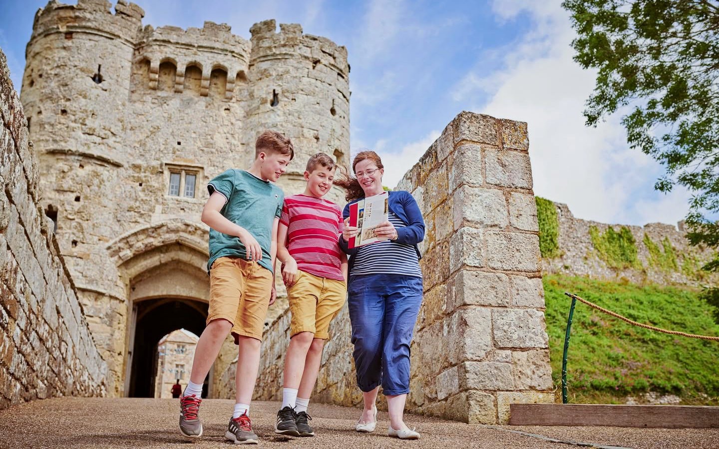 Visitors exploring Carisbrooke Castle entrance, Isle of Wight.