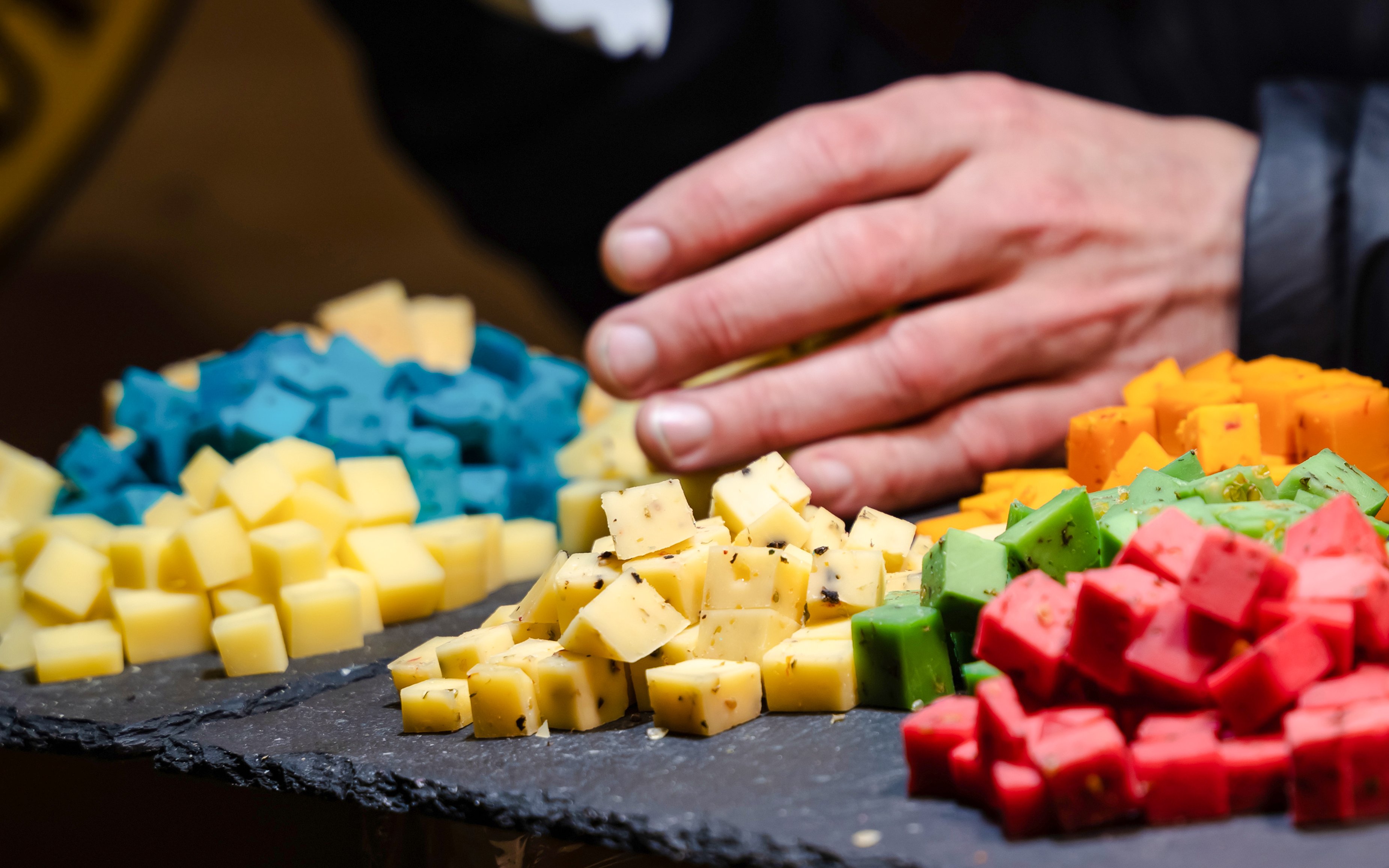 Colorful cheese cubes on slate at Hotel Müller Restaurant.