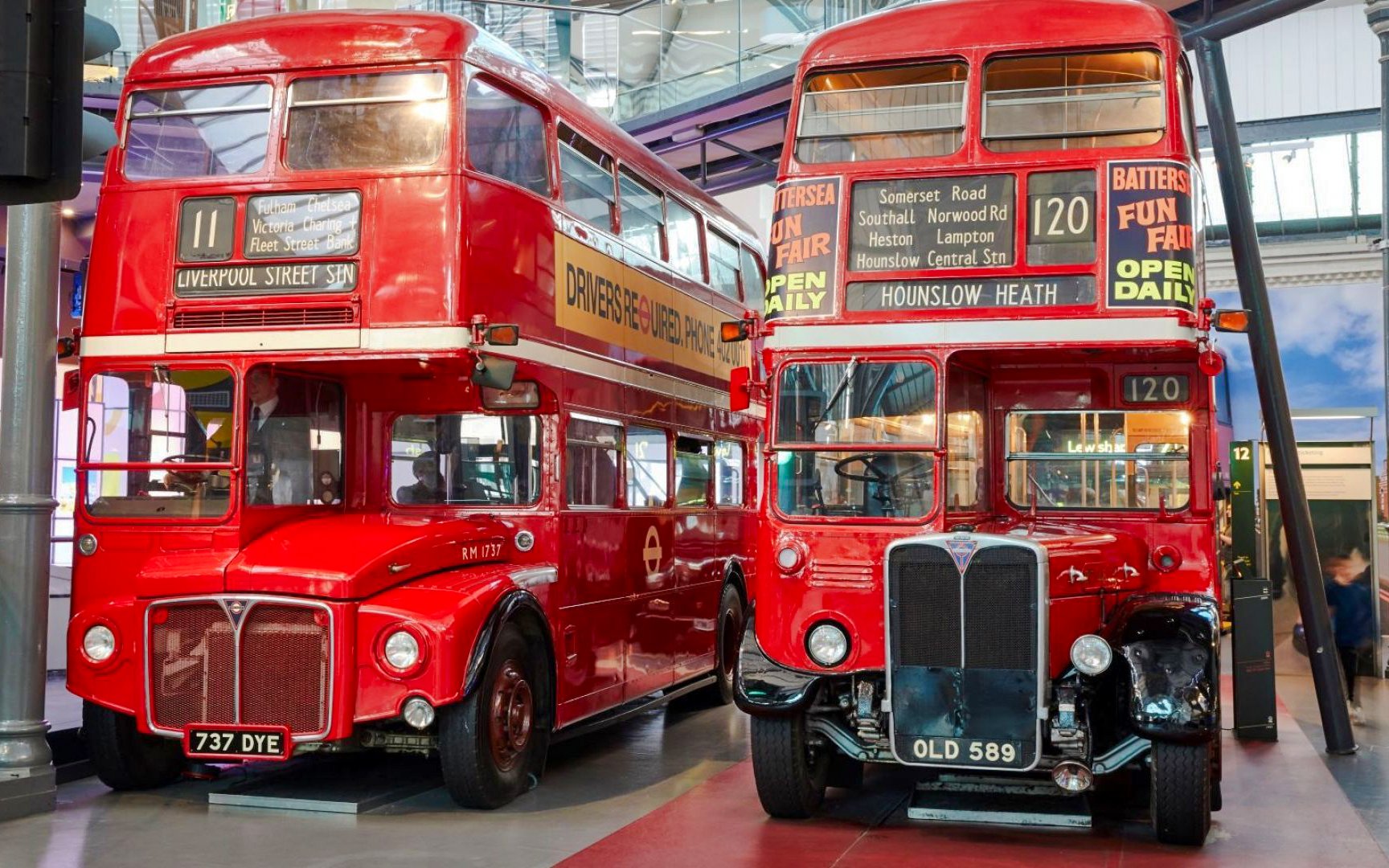 Vintage red double-decker buses on display at the London Transport Museum.