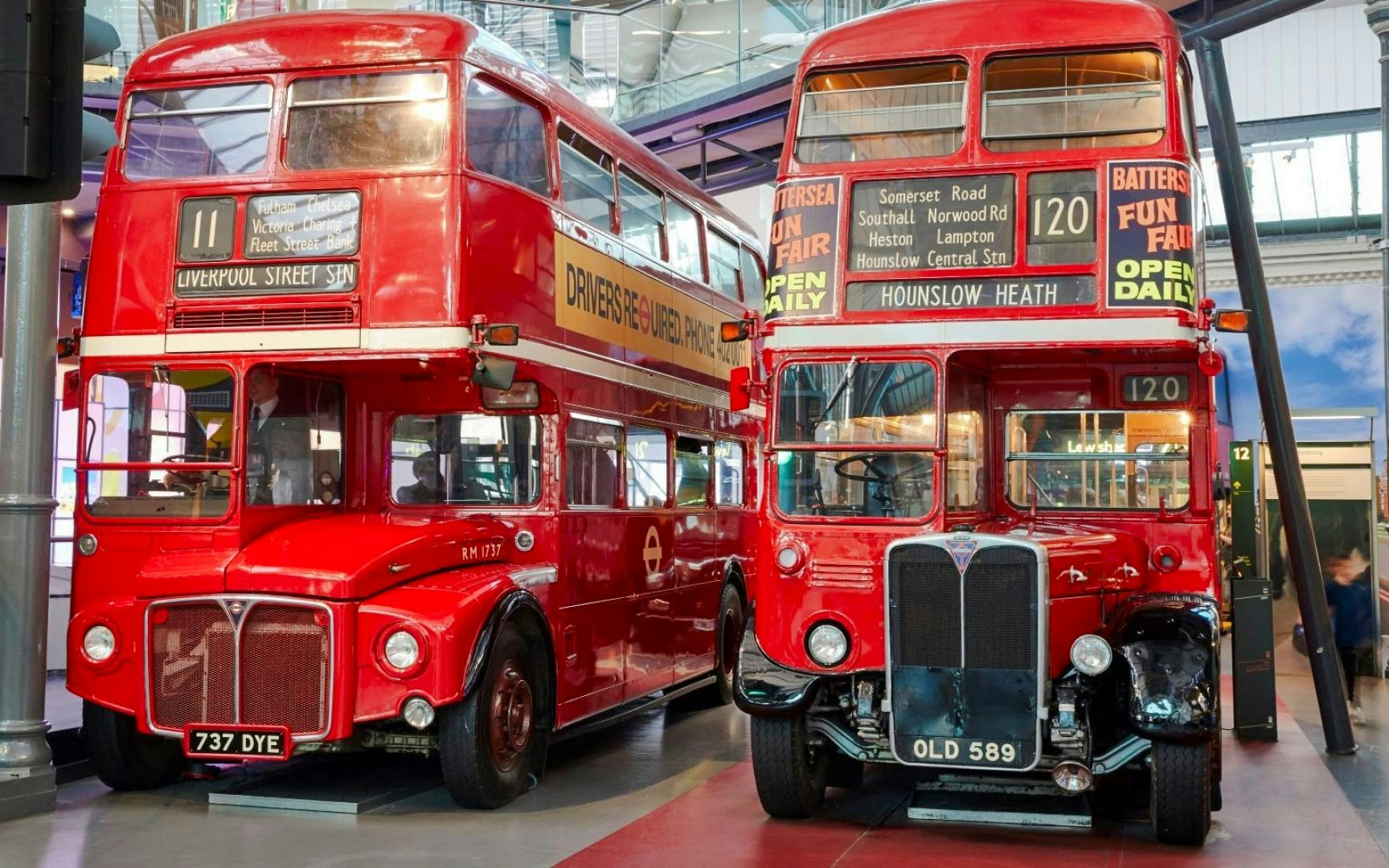 Vintage red double-decker buses on display at the London Transport Museum.