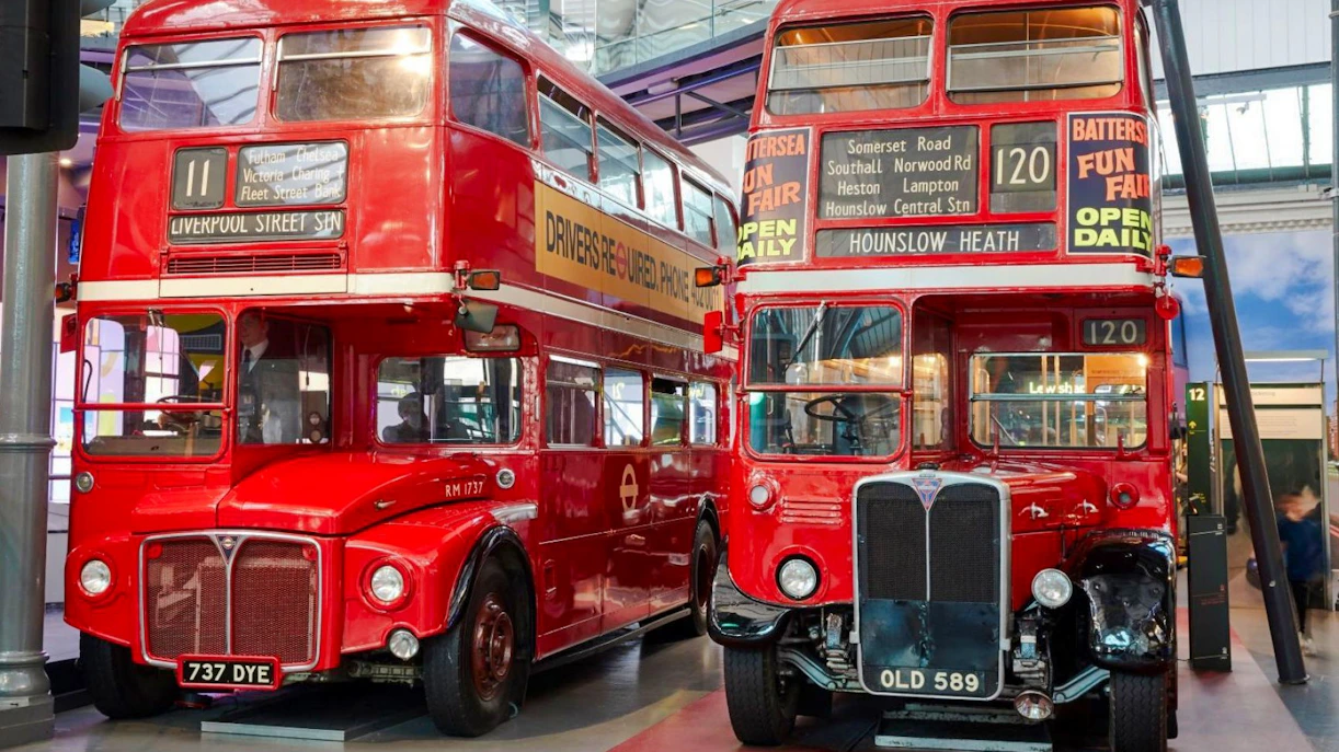 Vintage red double-decker buses on display at the London Transport Museum.