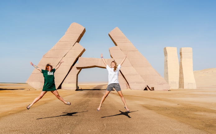Girls jumping near the Gate of Allah in Ras Mohammed National Park, Egypt.
