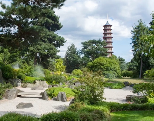 Distant view of the Great Pagoda at Kew Gardens, London, surrounded by lush greenery.