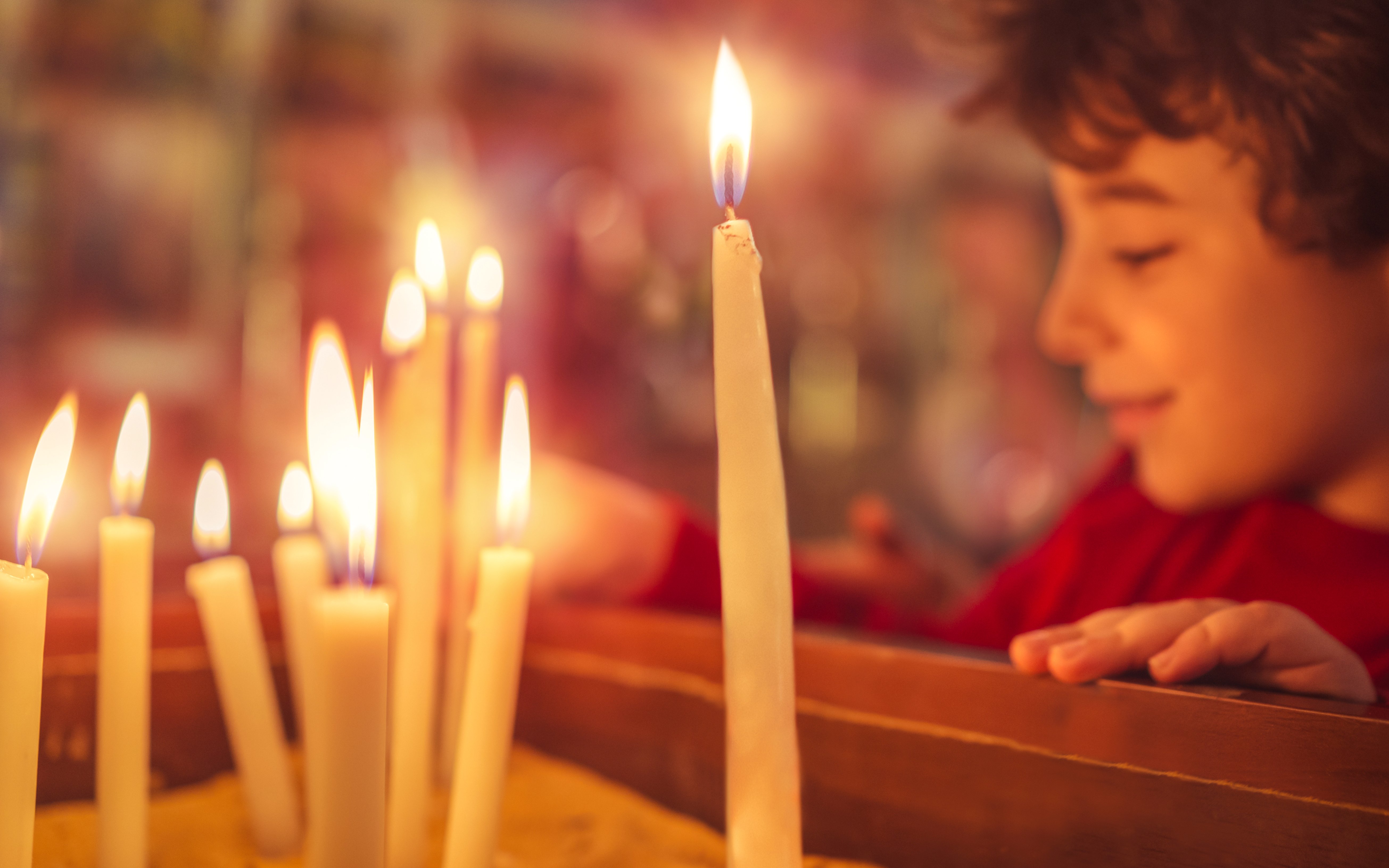 Candles lit during Christmas service at Canterbury Cathedral.