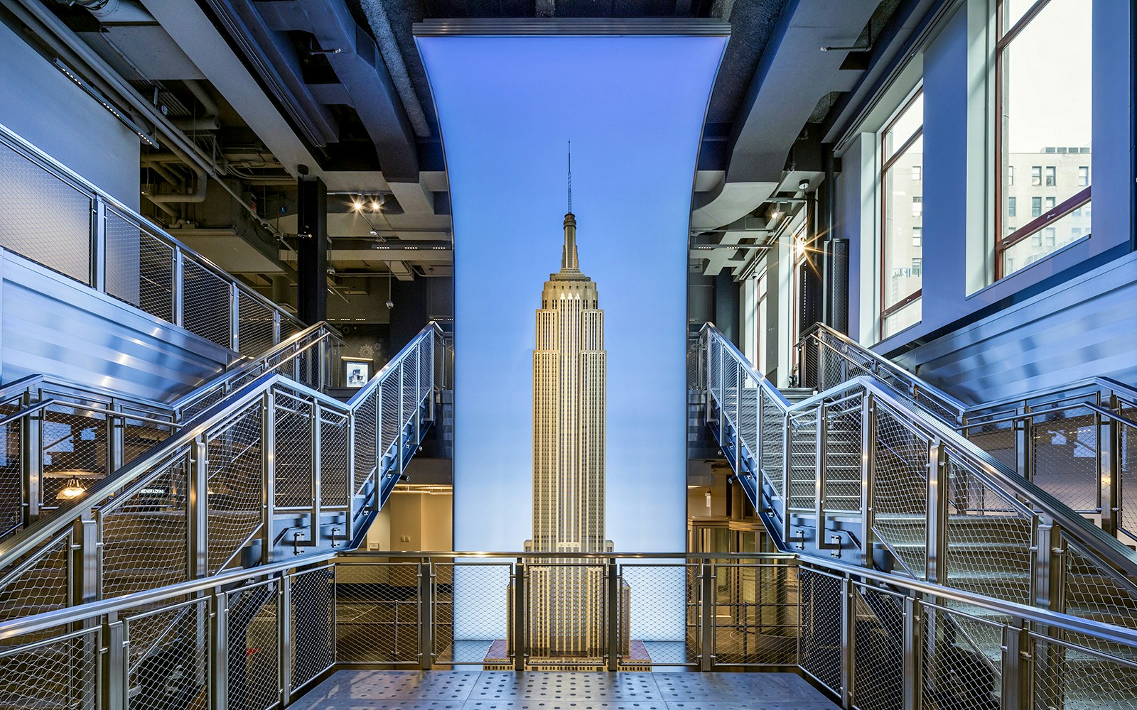 Tourists viewing New York City skyline from Empire State Building Observatory with skip-the-line tickets.