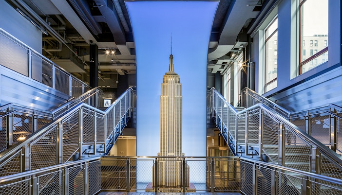 Tourists enjoying the breathtaking city view from Empire State Building Observatory