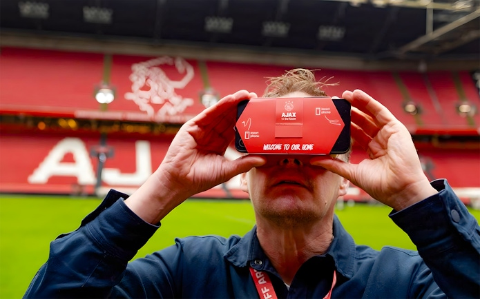 Visitor using VR headset at Johan Cruijff ArenA during Classic Tour in Amsterdam.