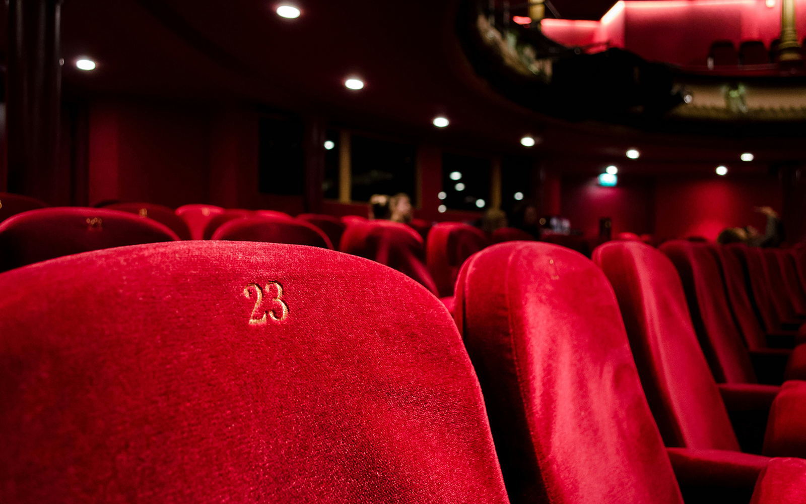 Red velvet seats in a grand opera house theatre.
