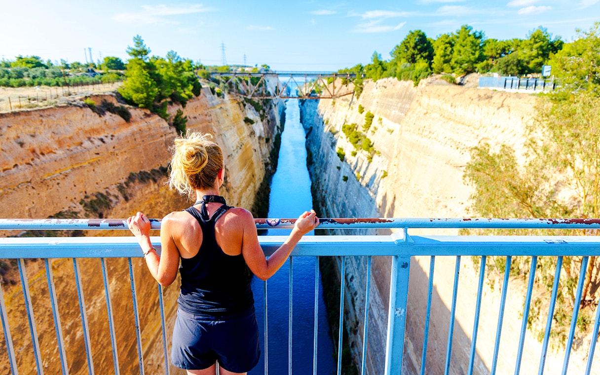 Person overlooking the Corinth Canal in Greece from a bridge.