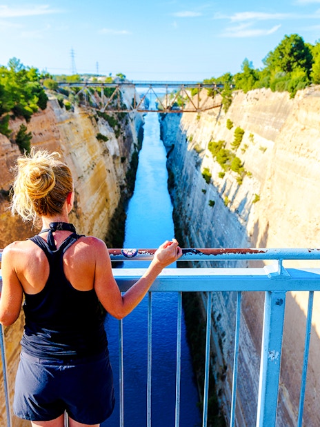 Person overlooking the Corinth Canal in Greece from a bridge.