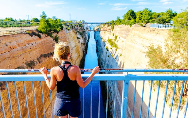 Person overlooking the Corinth Canal in Greece from a bridge.