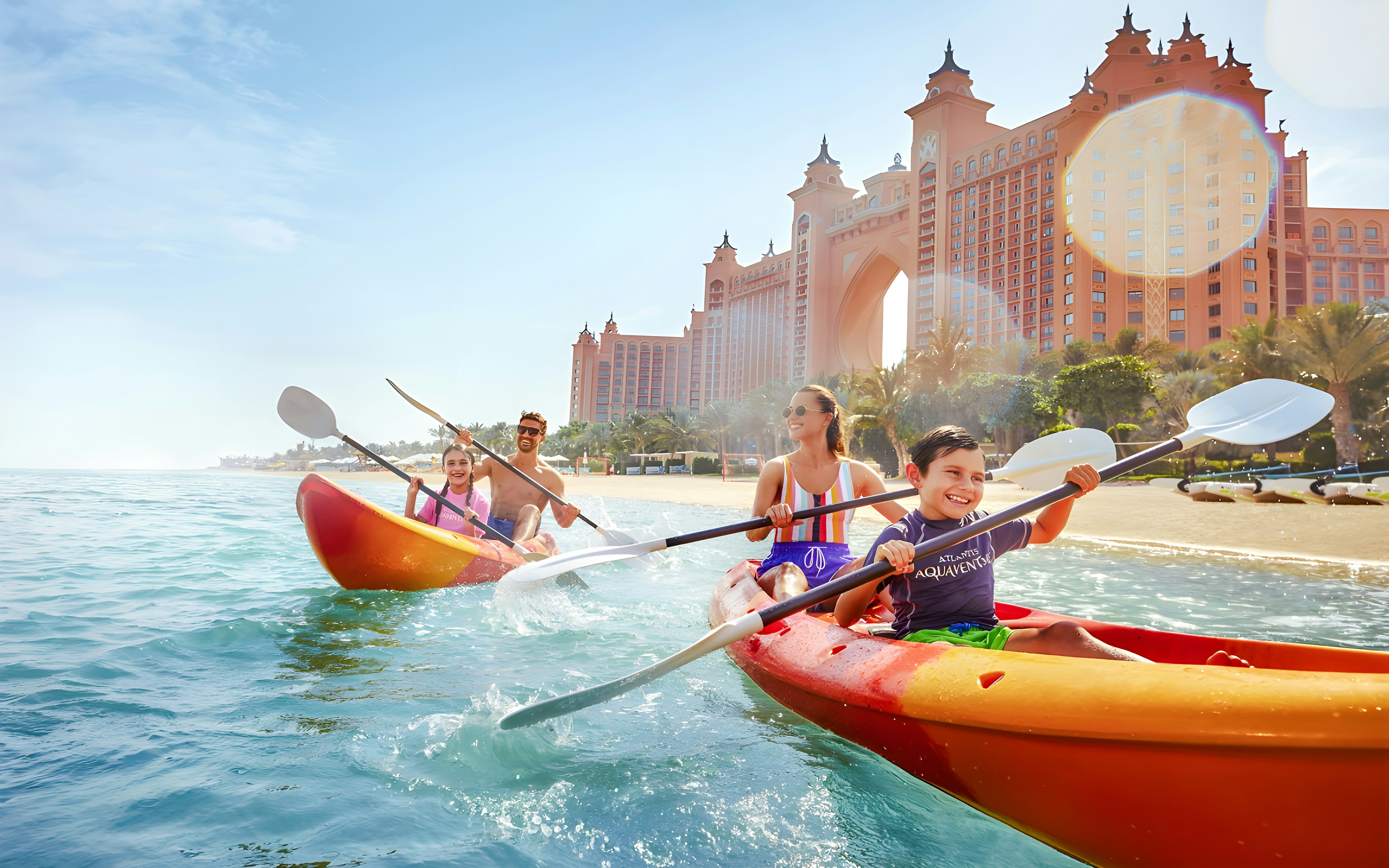 Family kayaking in double kayaks at Atlantis, The Palm, Dubai.