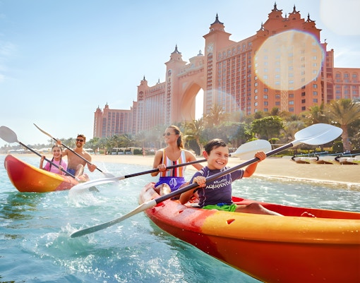 Family kayaking in double kayaks at Atlantis, The Palm, Dubai.