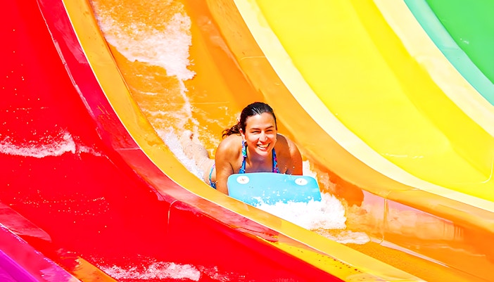 Kangaroa water slide at Aquopolis with people enjoying the thrilling descent in La Pineda, Spain.