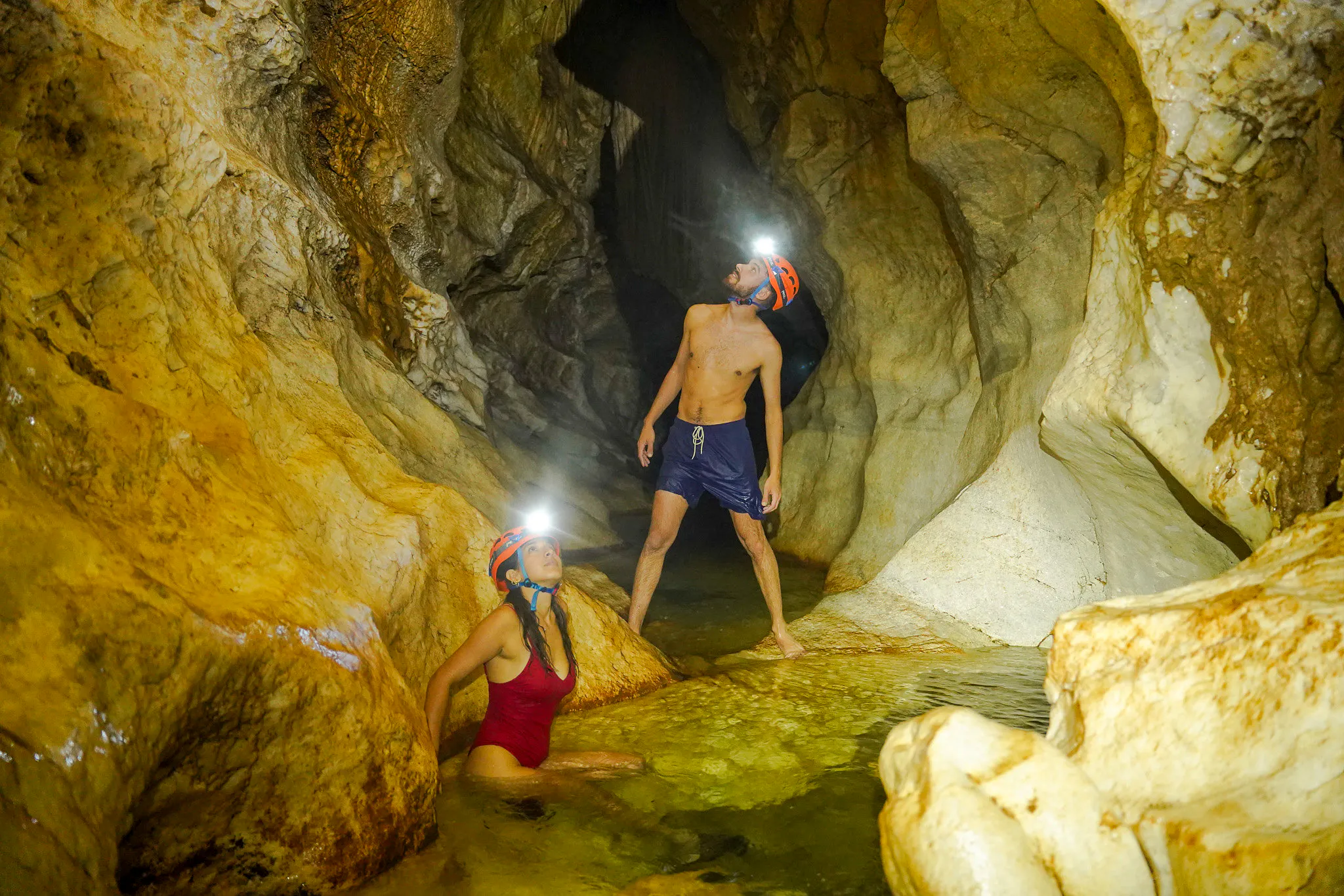 Exploring a cave with headlamps during Ba Be Nature Escape tour, Hanoi.