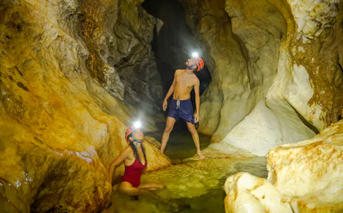 Exploring a cave with headlamps during Ba Be Nature Escape tour, Hanoi.