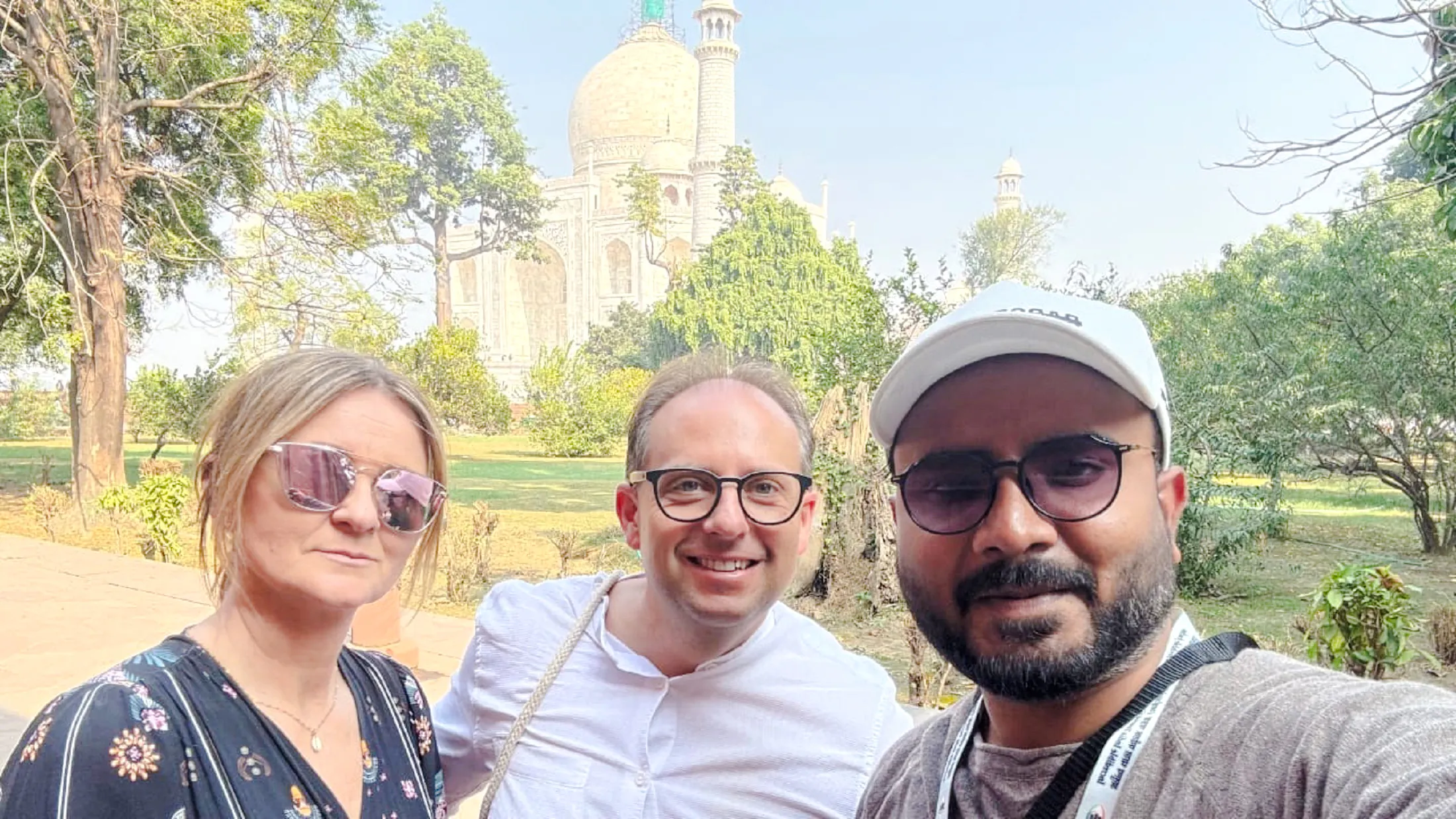 Tourists in front of the Taj Mahal during the Agra tour from Delhi.