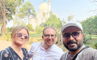 Tourists in front of the Taj Mahal during the Agra tour from Delhi.