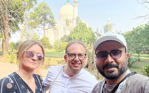 Tourists in front of the Taj Mahal during the Agra tour from Delhi.