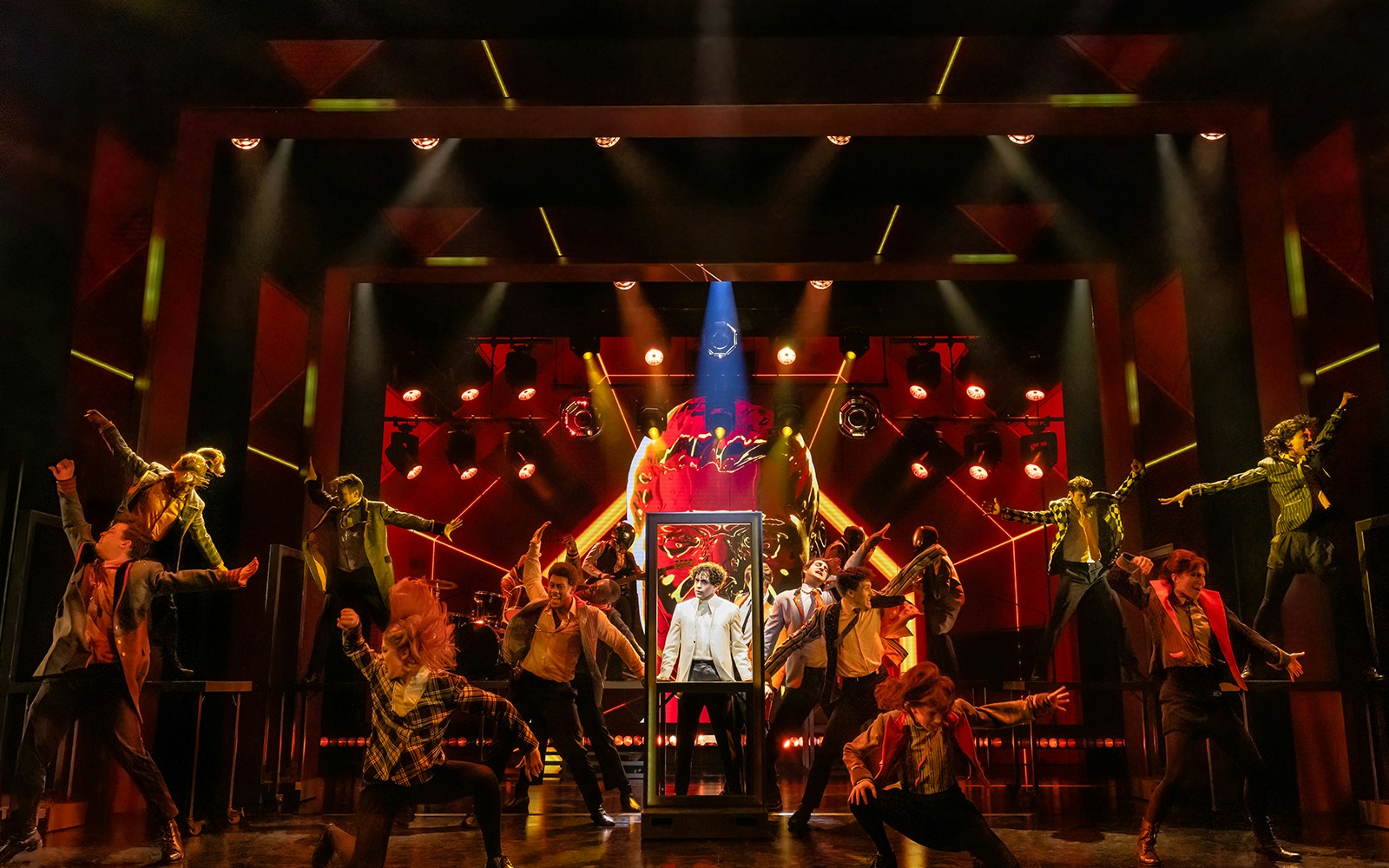 Stage performance of The Who's Tommy with dynamic lighting and energetic dancers.
