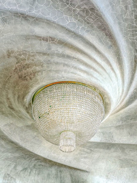 Casa Batlló ceiling with ornate chandelier, Barcelona.