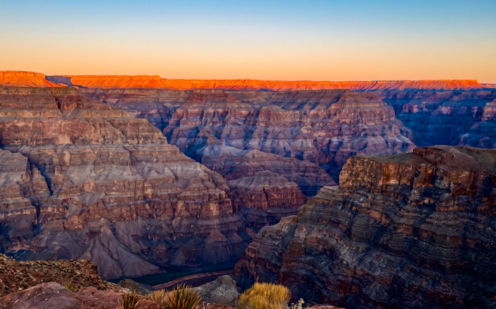 Grand Canyon West at sunset with vibrant canyon colors and expansive views.