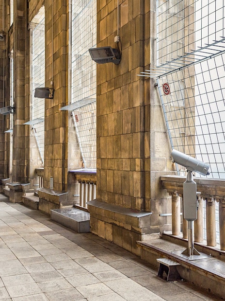 Visitors terrace at Palace of Culture and Science, Warsaw, with viewing telescope and stone columns.