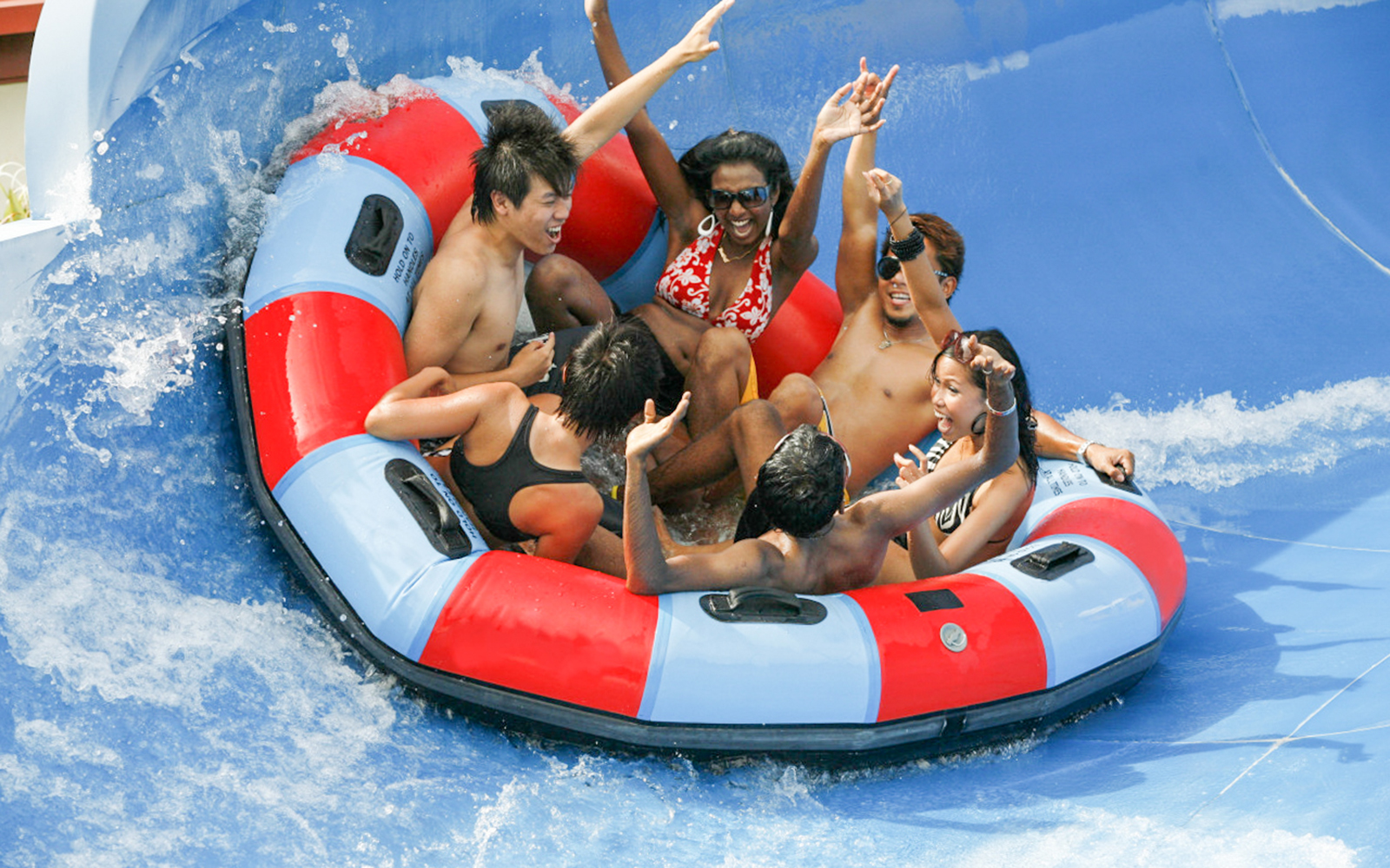 Group enjoying a raft ride at Wild Wild Wet water park, Singapore.