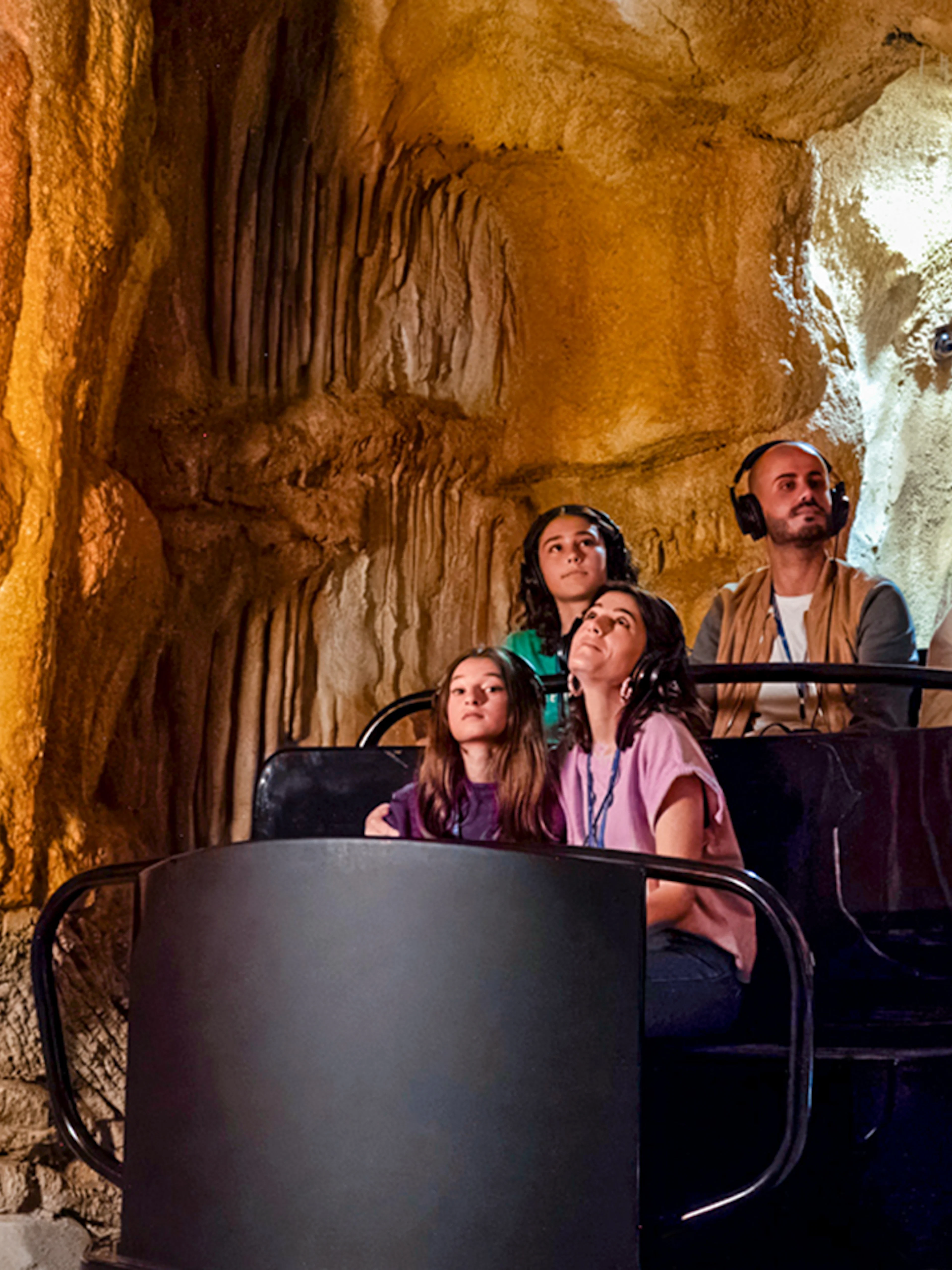 Visitors exploring Cosquer Cave in Marseille with audio guides.