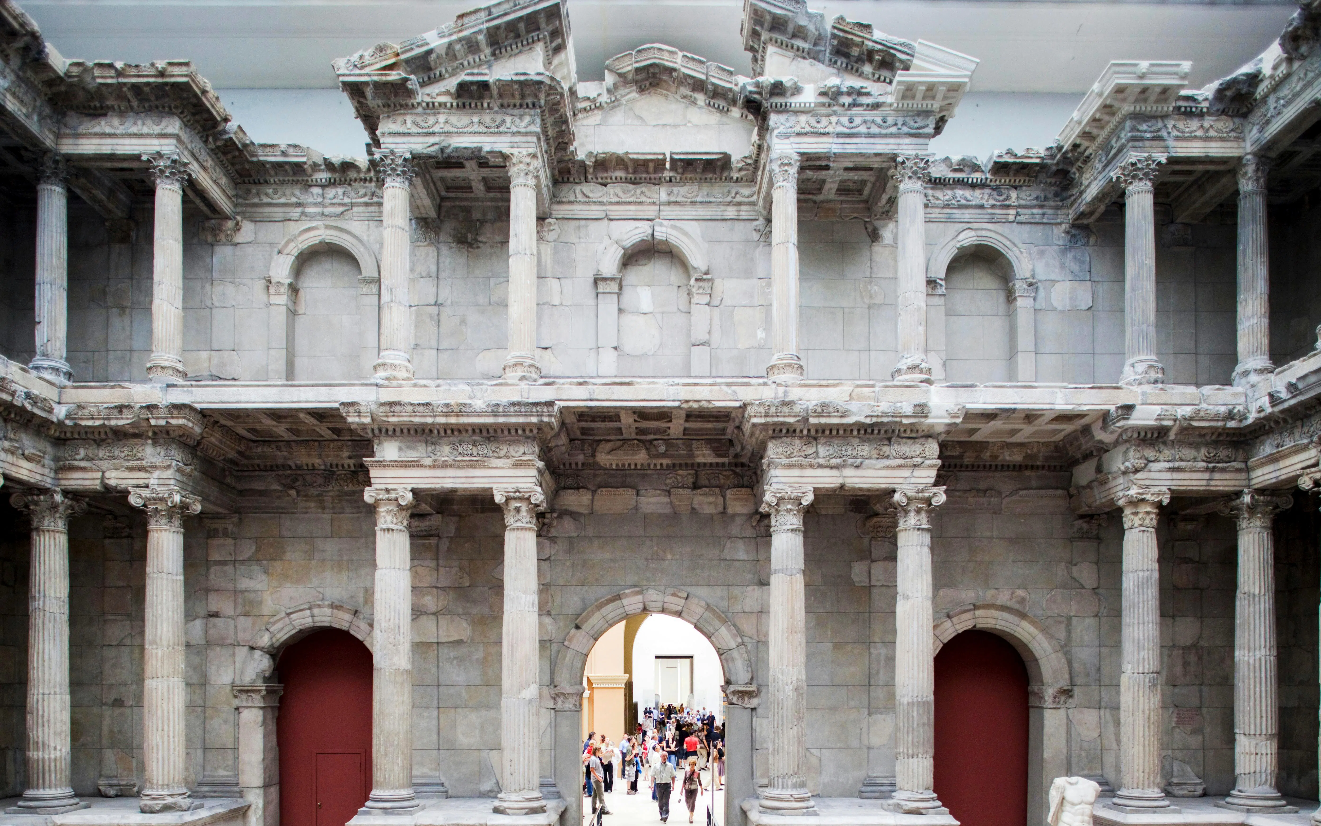 Pergamon Museum's Market Gate of Miletus in Berlin with visitors exploring.