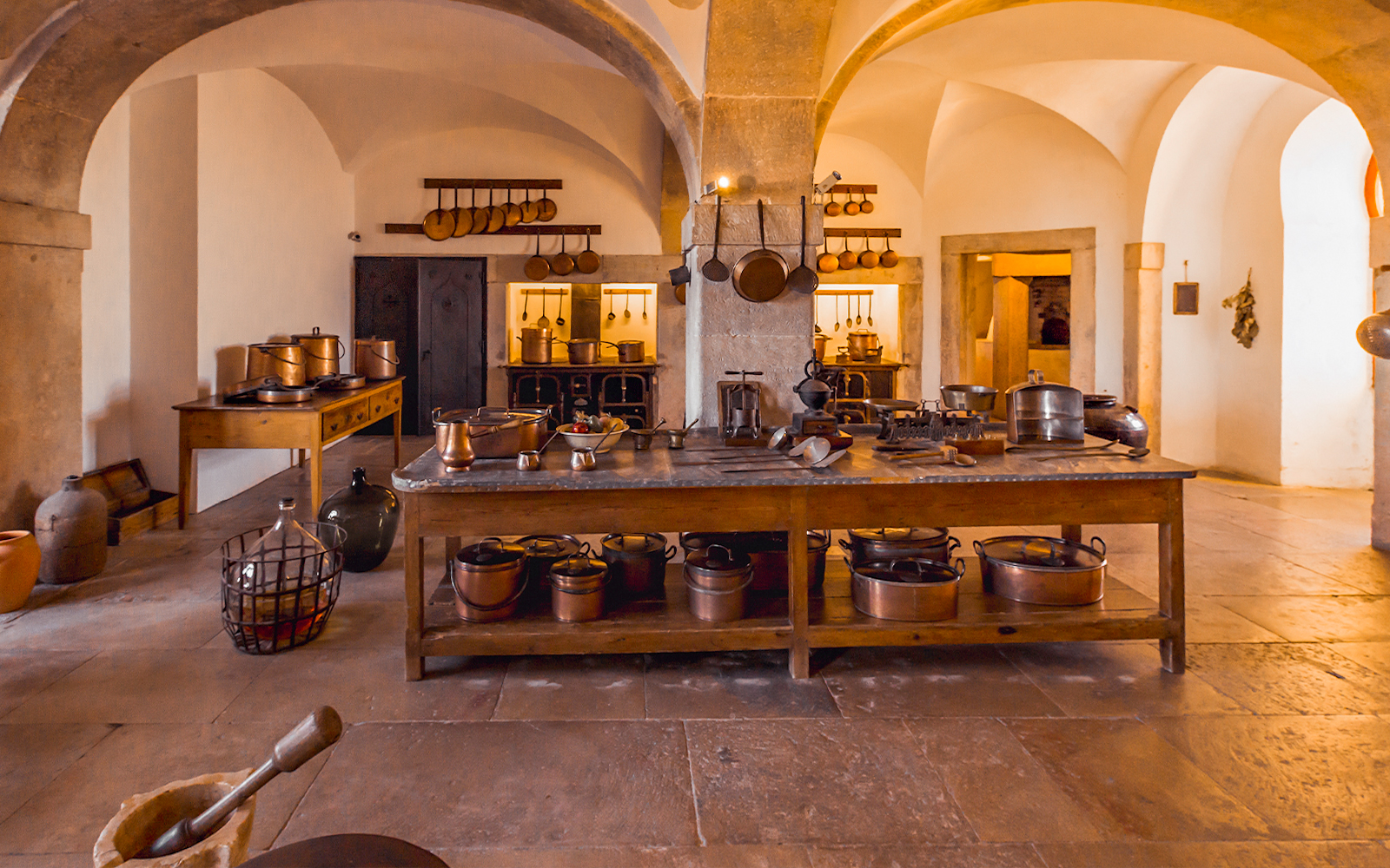Crockery Room in Sintra National Palace with copper pots and rustic kitchenware.