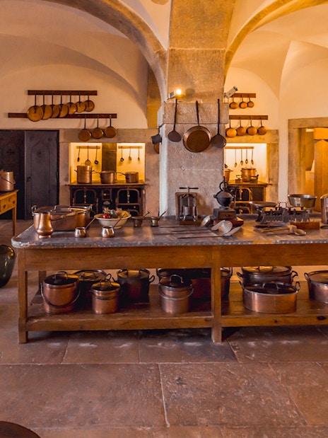 Crockery Room in Sintra National Palace with copper pots and rustic kitchenware.
