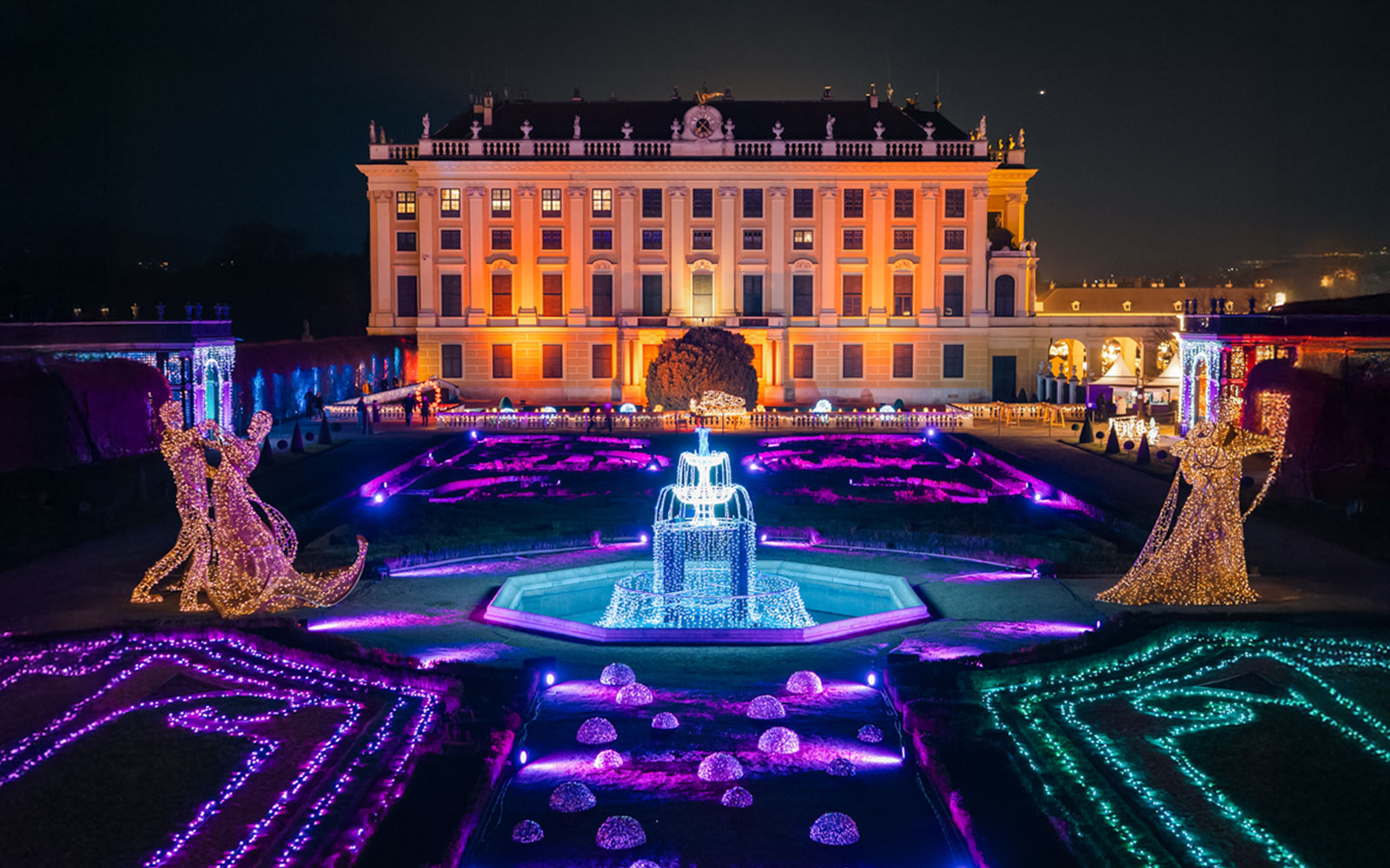 Schönbrunn Palace illuminated with Christmas lights during Vienna tour.