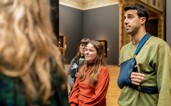 Visitors on a guided tour inside the Rijksmuseum, Amsterdam.