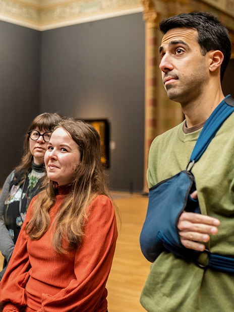 Visitors on a guided tour inside the Rijksmuseum, Amsterdam.