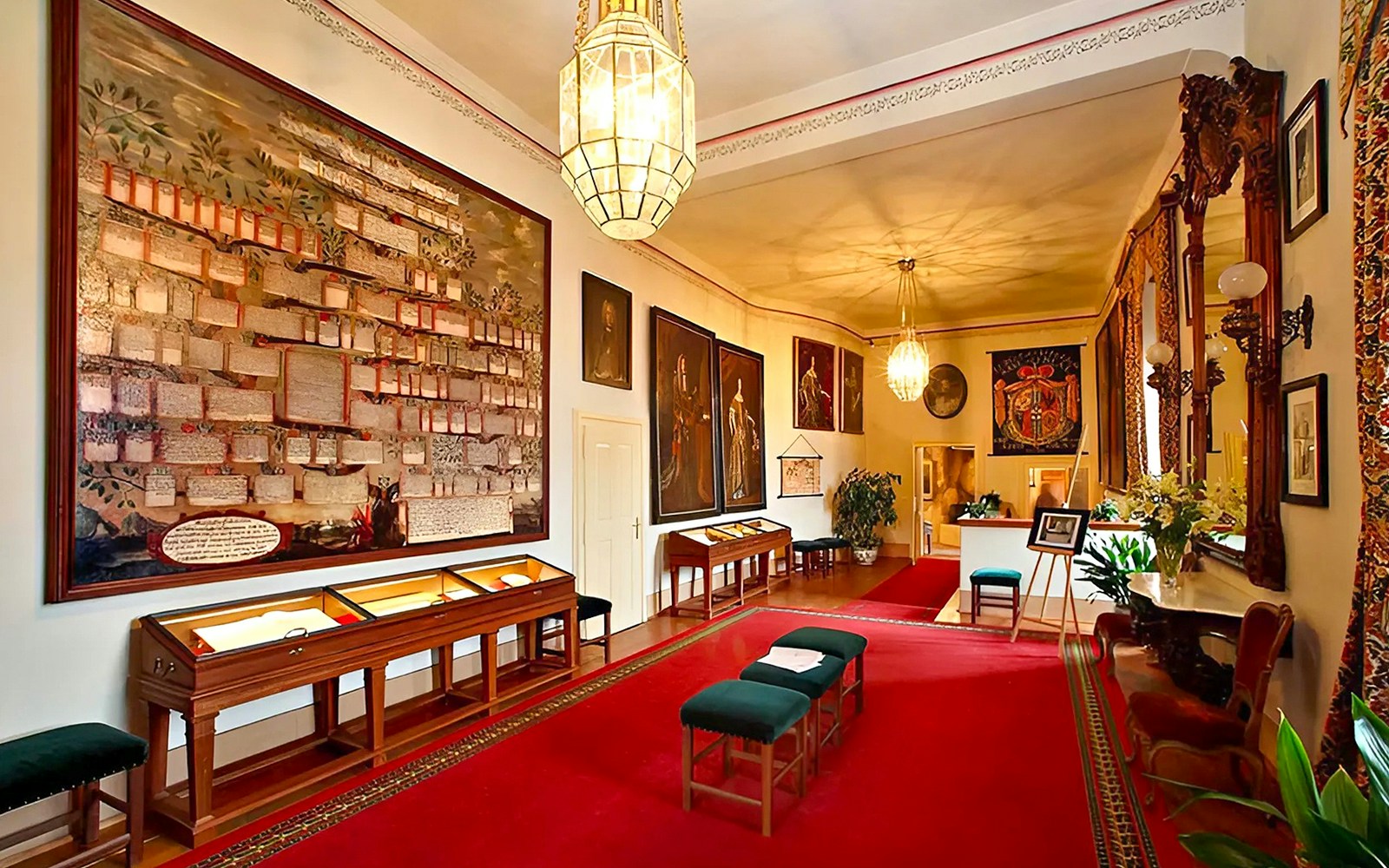 Cesky Krumlov Castle room with historical paintings and display cases.