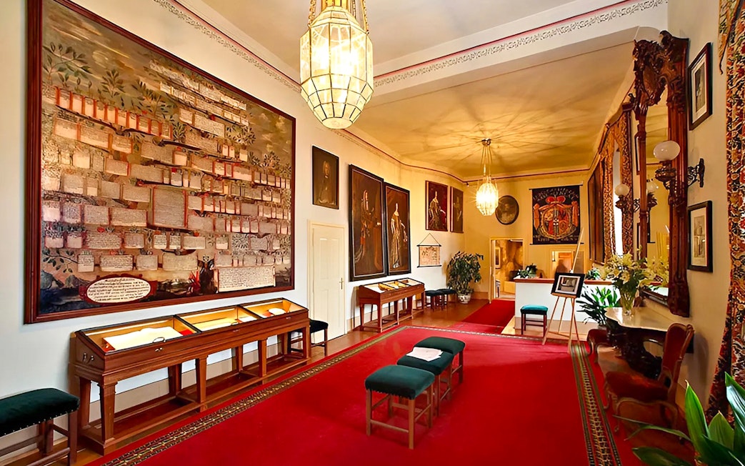 Cesky Krumlov Castle room with historical paintings and display cases.