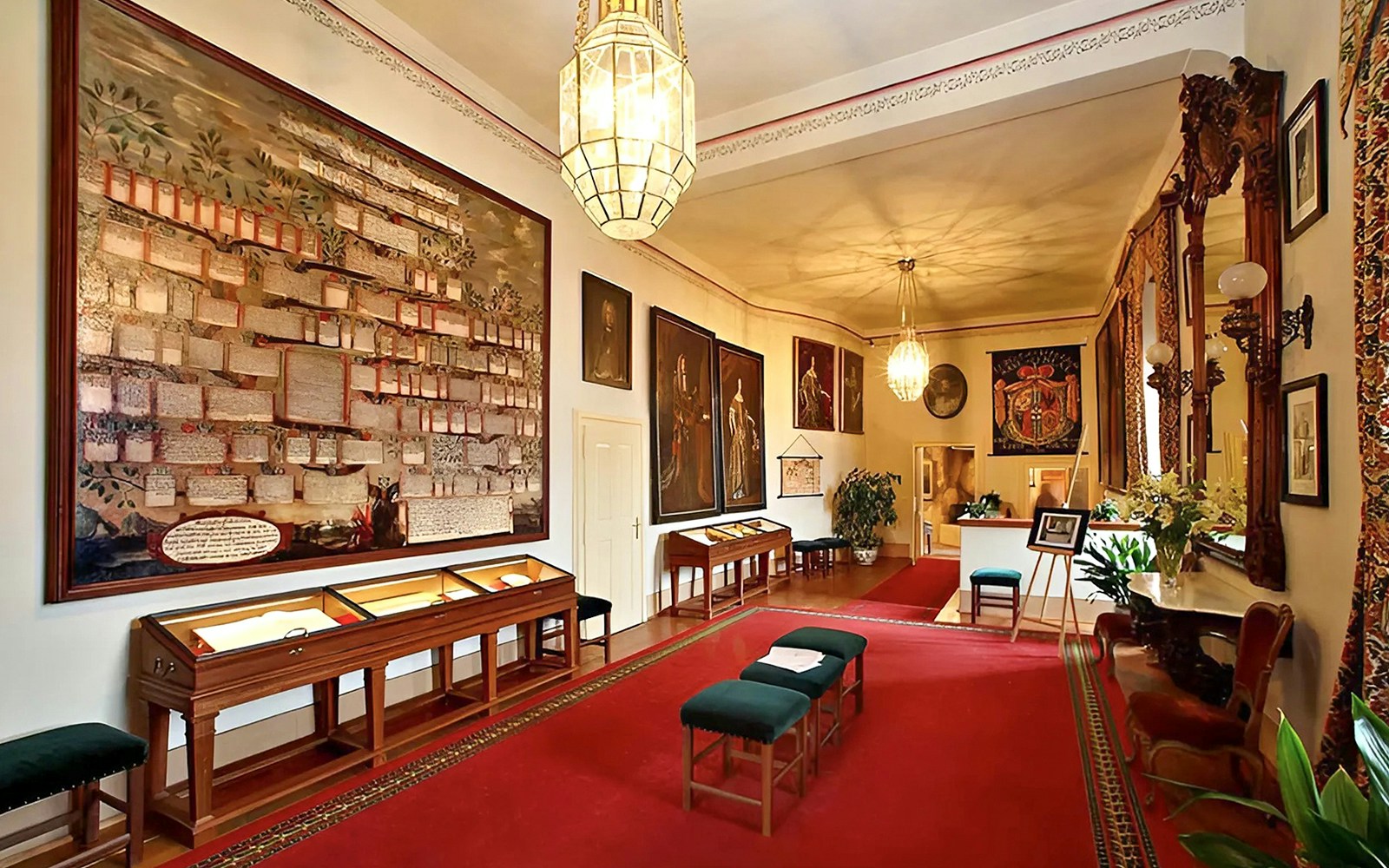 Cesky Krumlov Castle room with historical paintings and display cases.