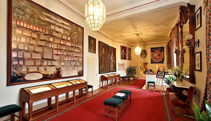 Cesky Krumlov castle interior showcasing ornate ceilings and historic furnishings.