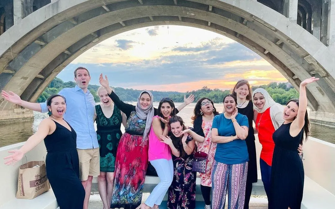 Group enjoying a Washington, DC yacht cruise with city views at sunset.
