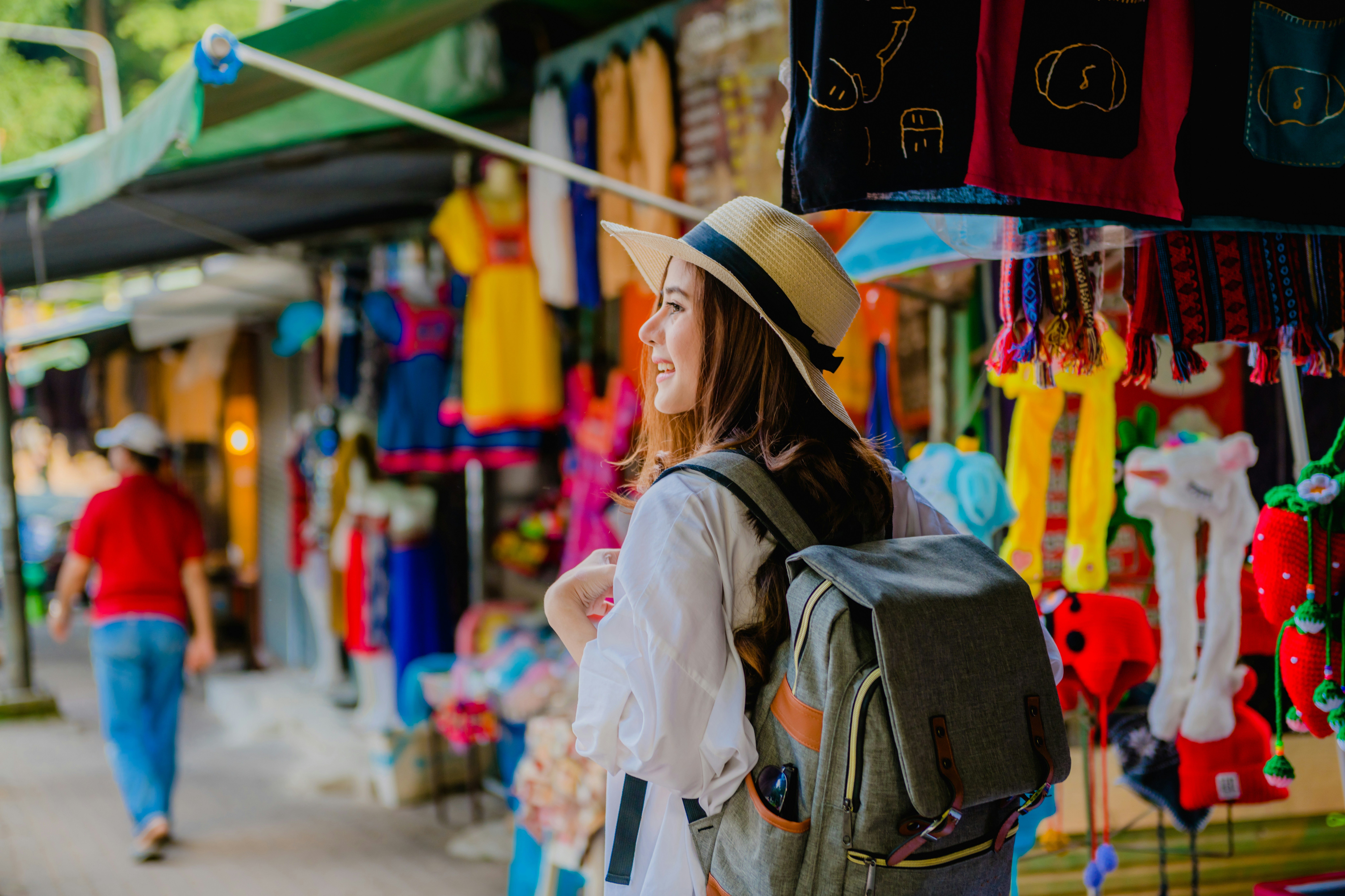Traveler with a backpack exploring a gift shop in Doi Pui village, Thailand.