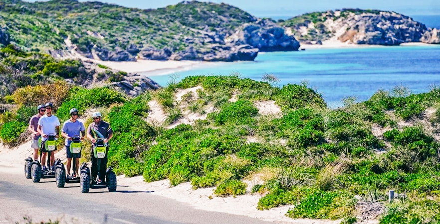 Segway tour group exploring Rottnest Island coast with ocean view.