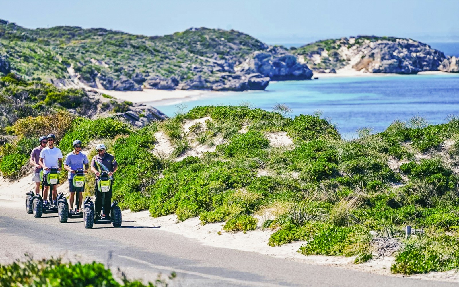 Segway tour group exploring Rottnest Island coast with ocean view.