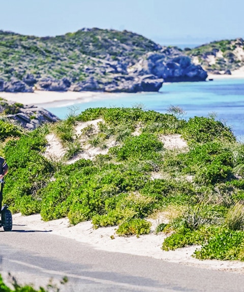 Segway tour group exploring Rottnest Island coast with ocean view.