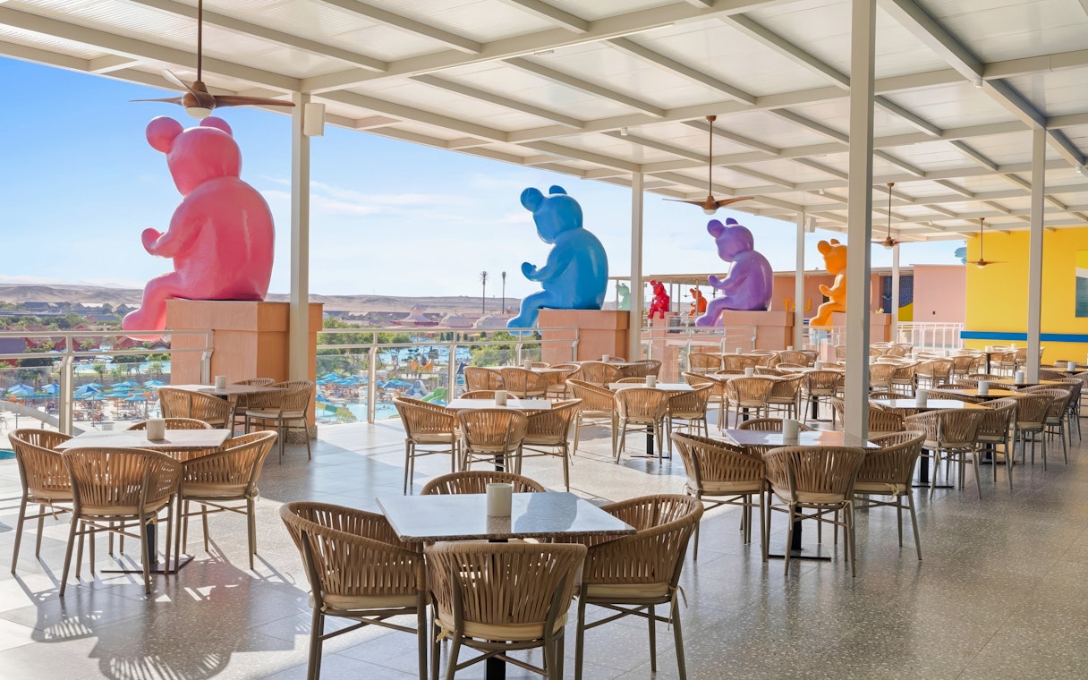 Outdoor dining area with colorful bear sculptures, Neverland Waterpark, Pickalbatros, Hurghada.
