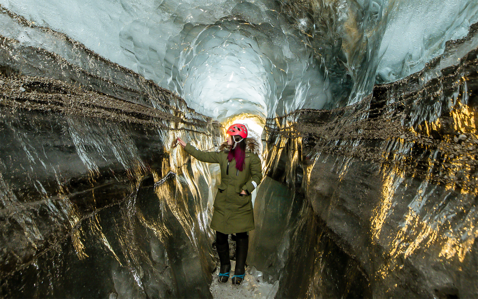 Guests exploring the icy passage of Katla Ice Cave in Iceland.