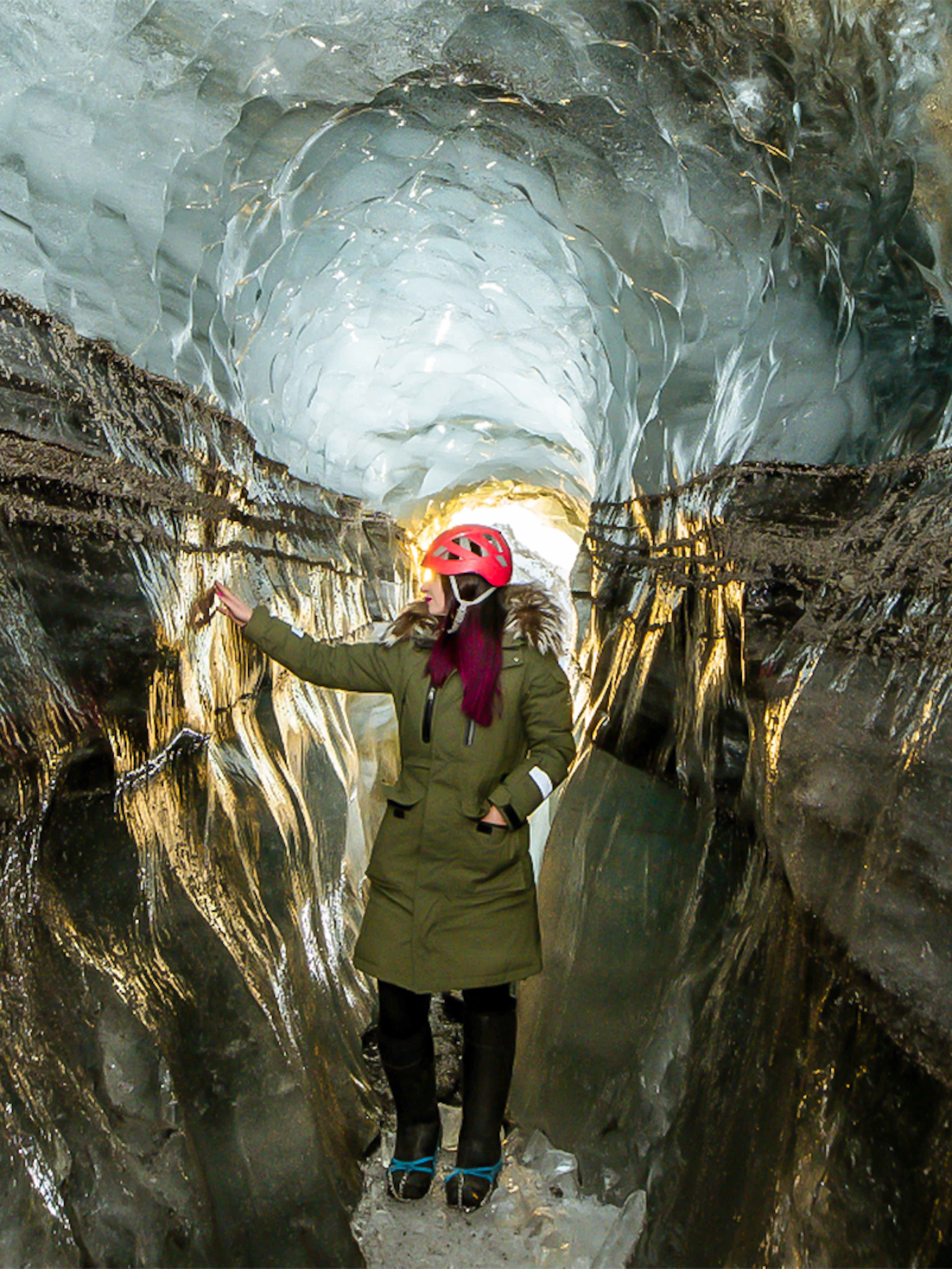 Guests exploring the icy passage of Katla Ice Cave in Iceland.