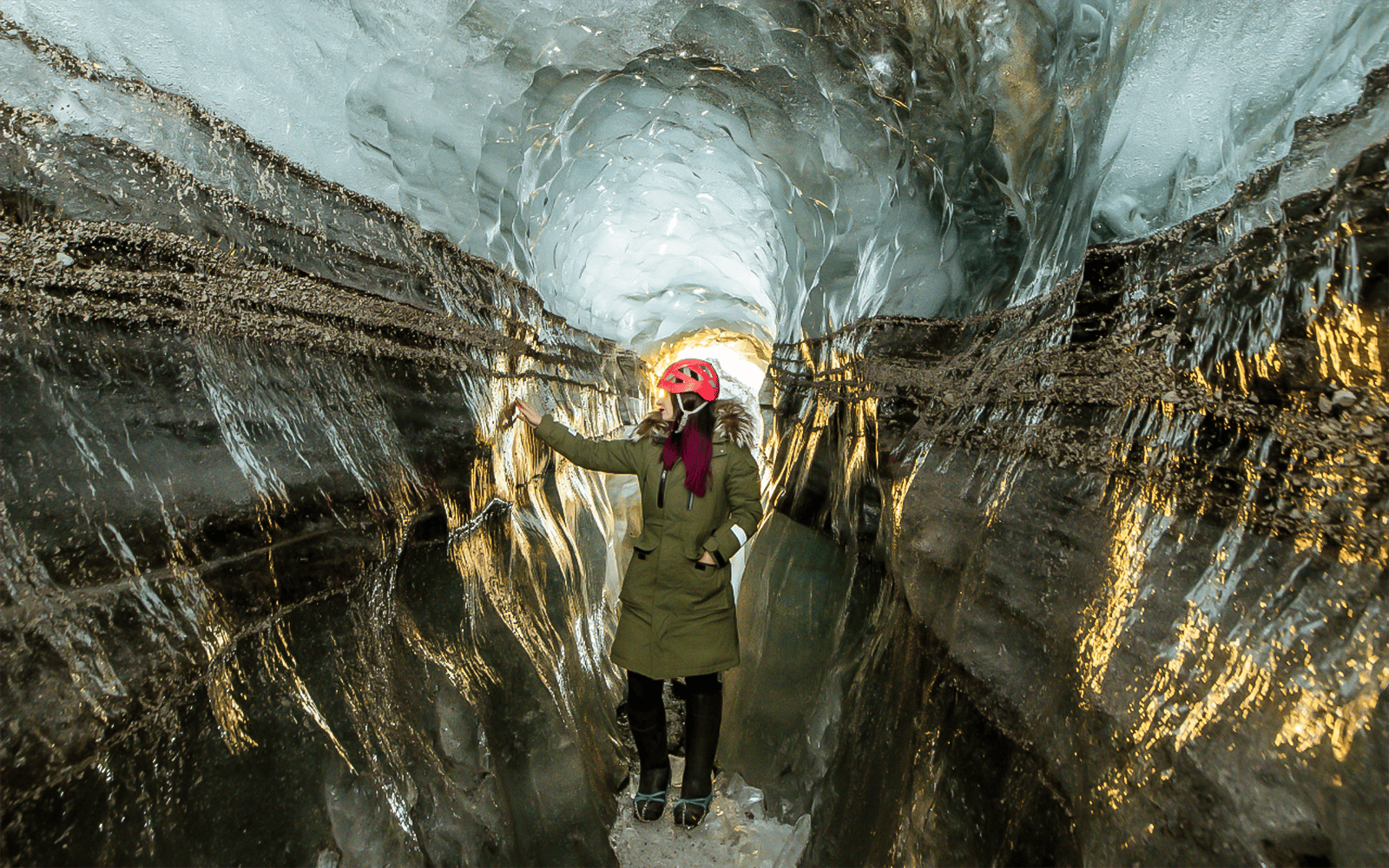 Guests exploring the icy passage of Katla Ice Cave in Iceland.