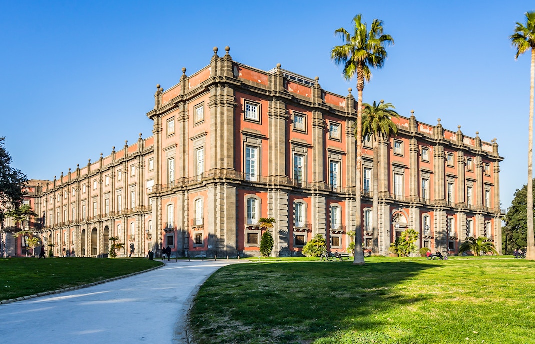 Museum of Capodimonte exterior with visitors exploring the historic architecture in Naples, Italy.