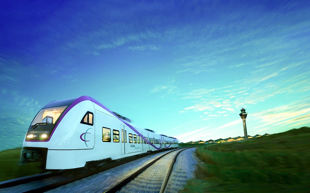 KLIA Express train traveling with control tower in the background, Malaysia.